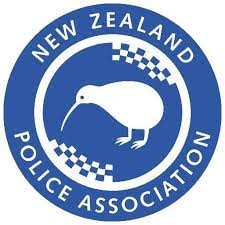 Logo of the New Zealand Police Association featuring a white kiwi bird and checkered design inside a blue circle.