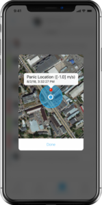 Smartphone screen displaying a security app with a map view. A red pin marks a “Panic Location” with a blue highlighted radius around it, showing coordinates and timestamp details. A “Done” button is visible below the map.